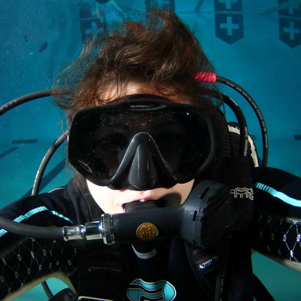 Students interacting with instructors in a dive shop