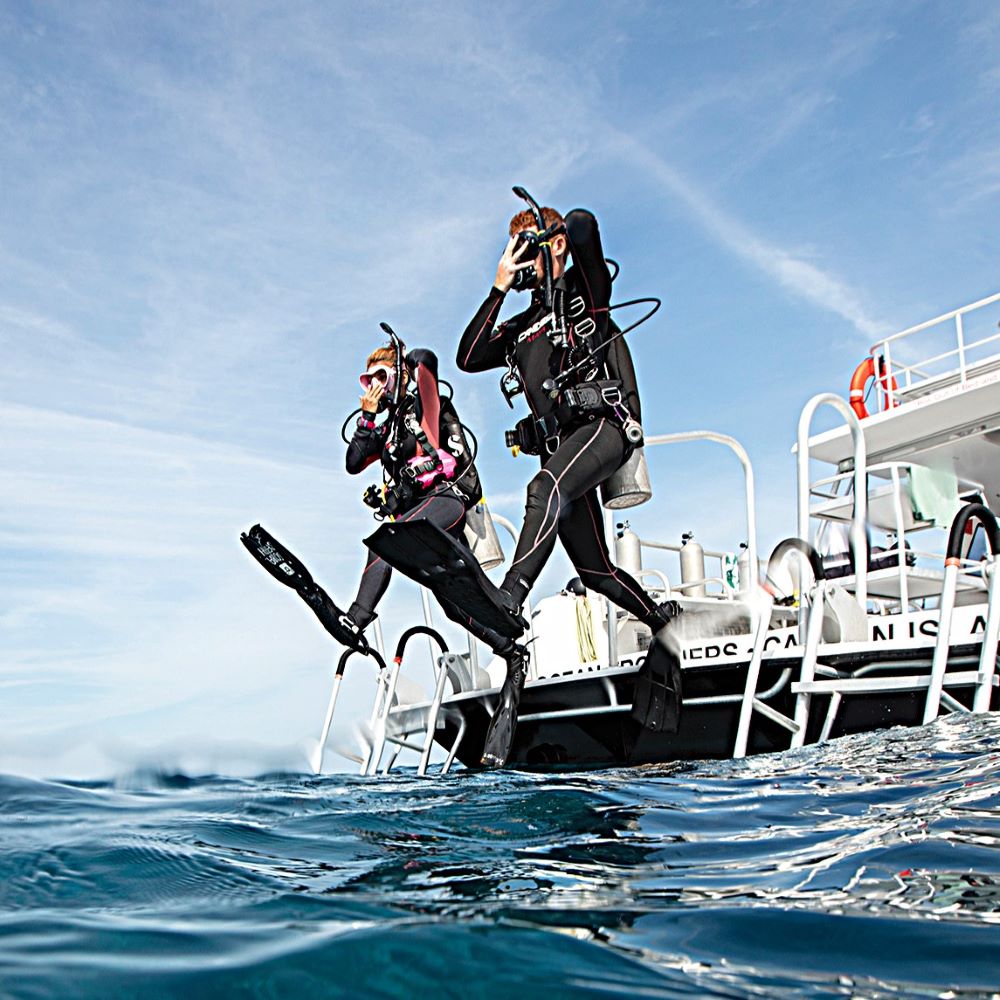 Helpful dive shop staff supporting a student